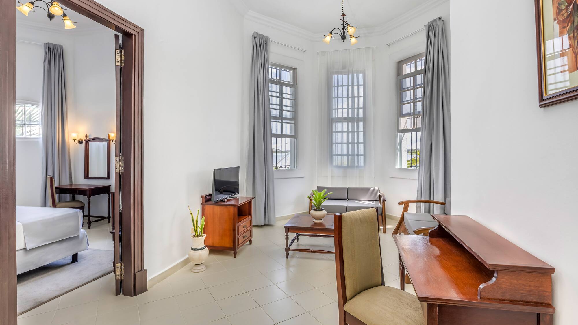 a room with a desk and chairs