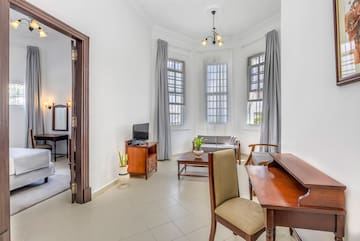 a room with a desk and chairs