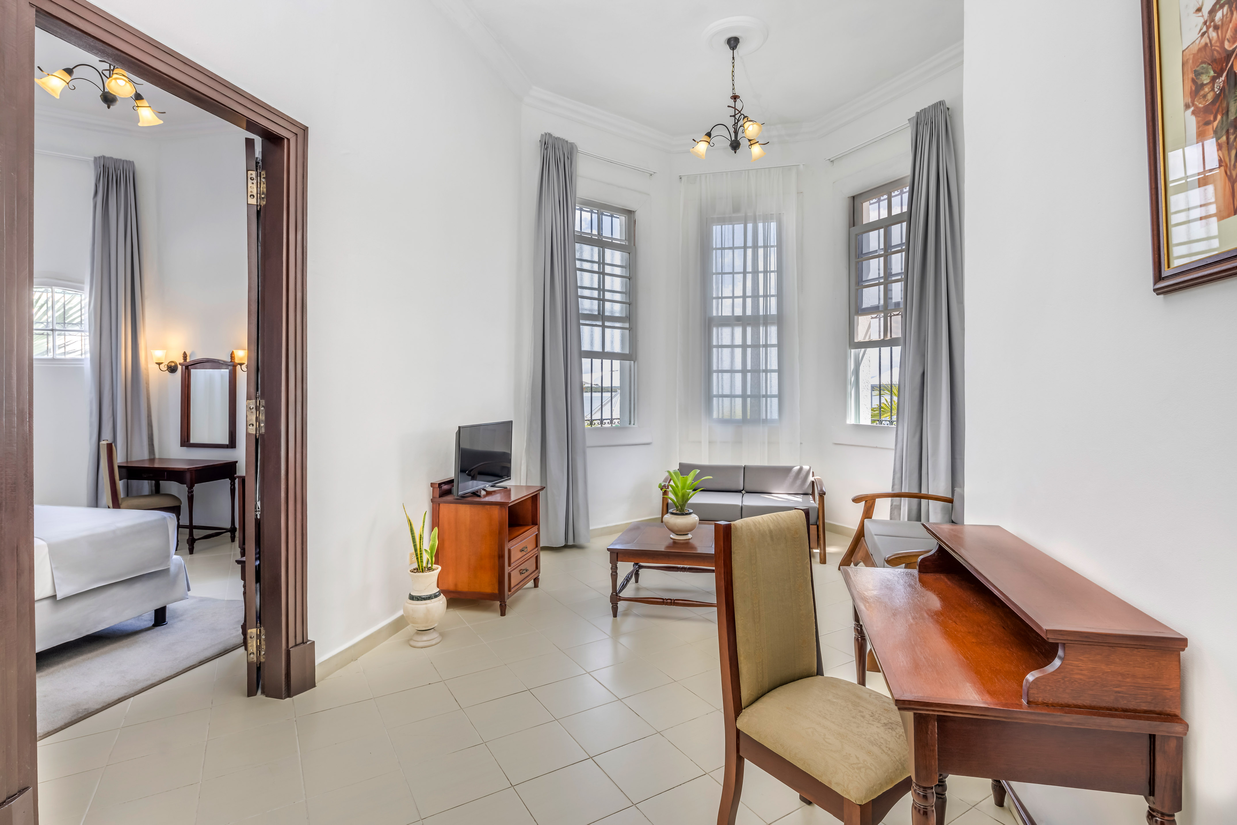 a room with a desk and chairs