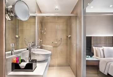 a bathroom with a glass shower and sink