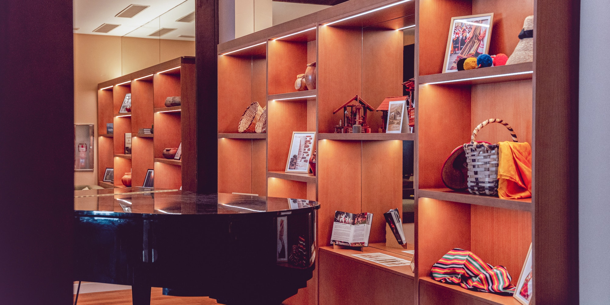 a room with a piano and shelves