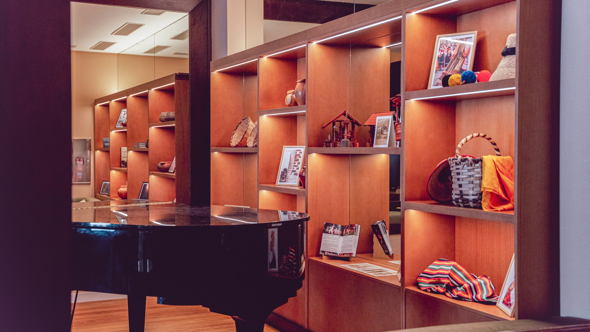 a room with a piano and shelves