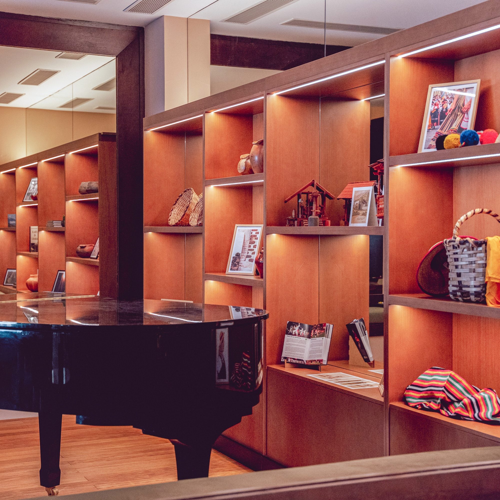 a room with a piano and shelves