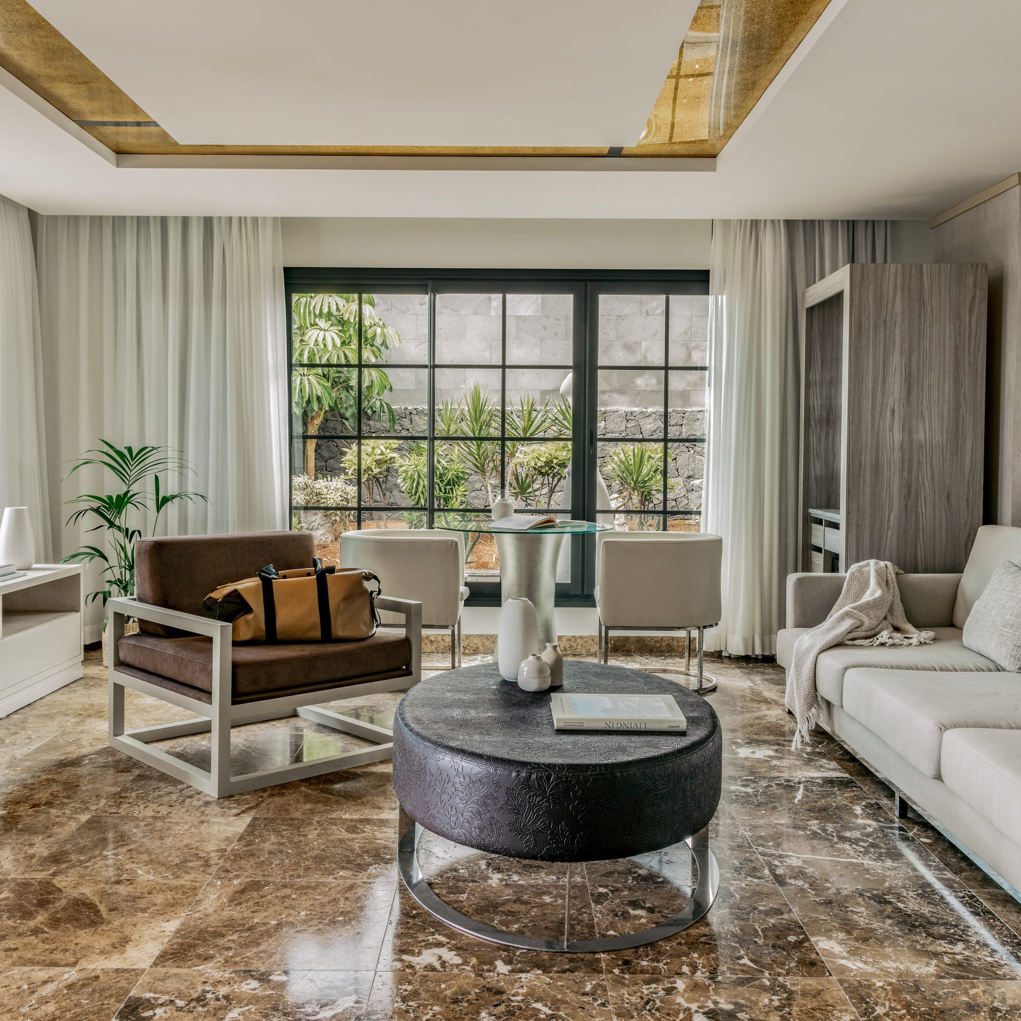 a living room with a couch and chairs