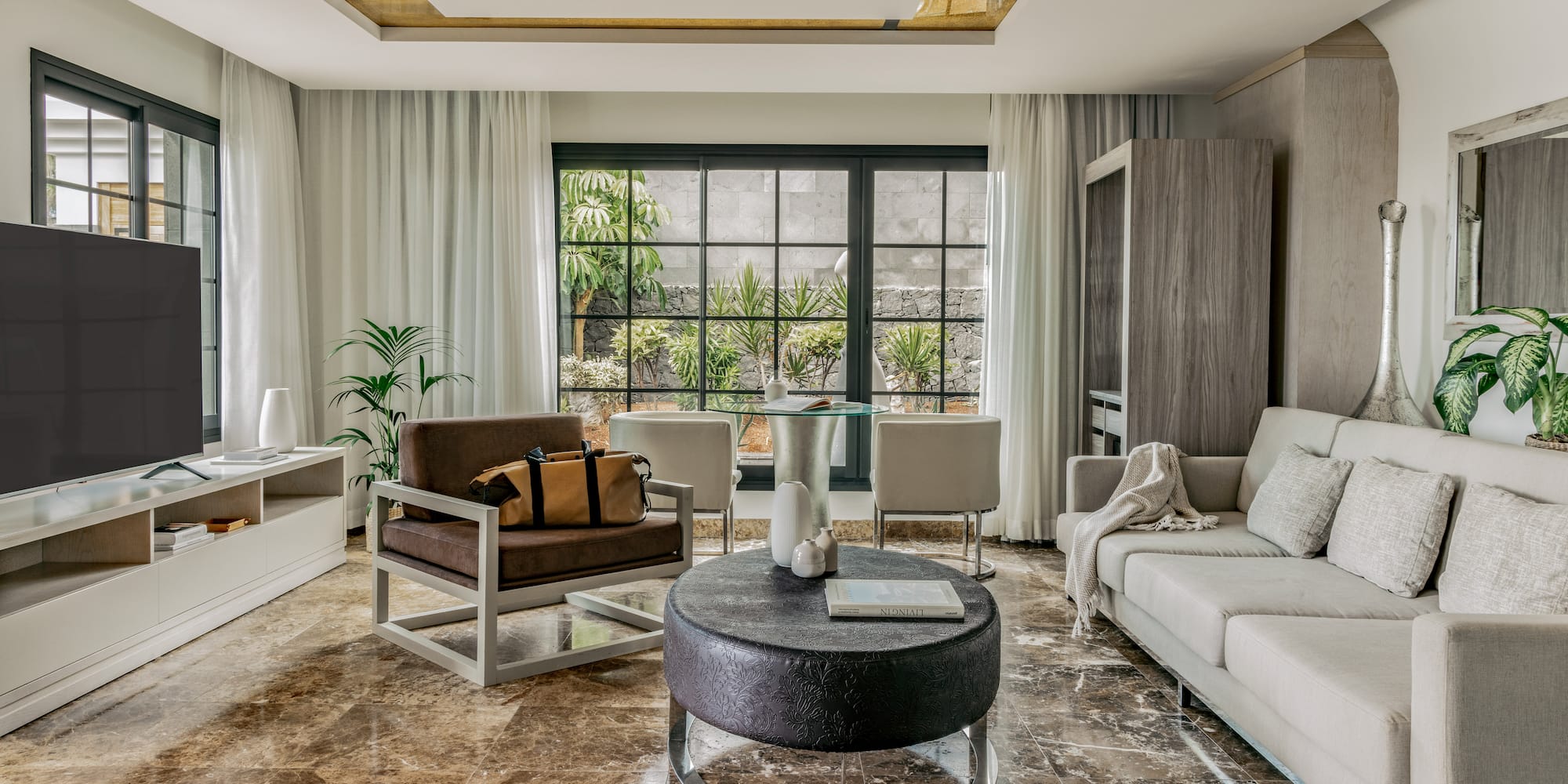 a living room with a couch and chairs