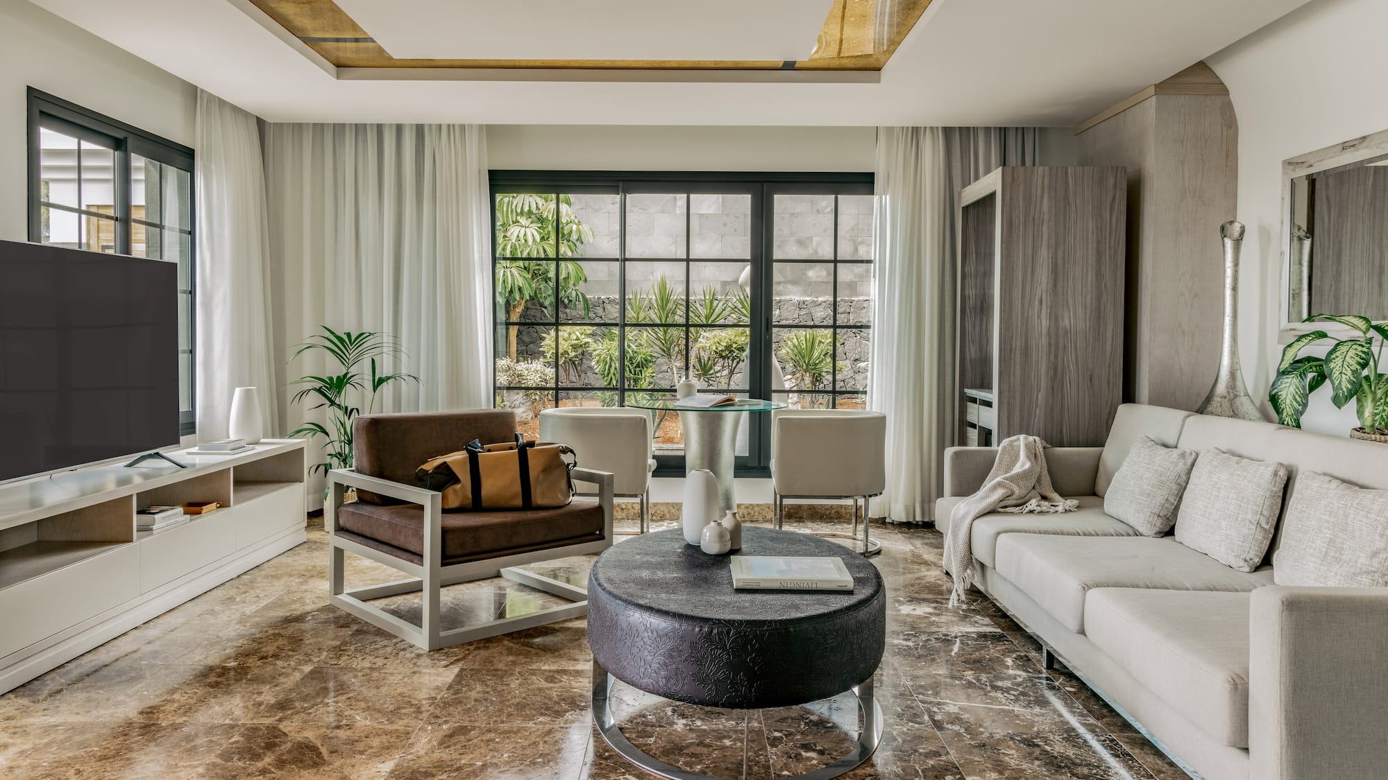 a living room with a couch and chairs