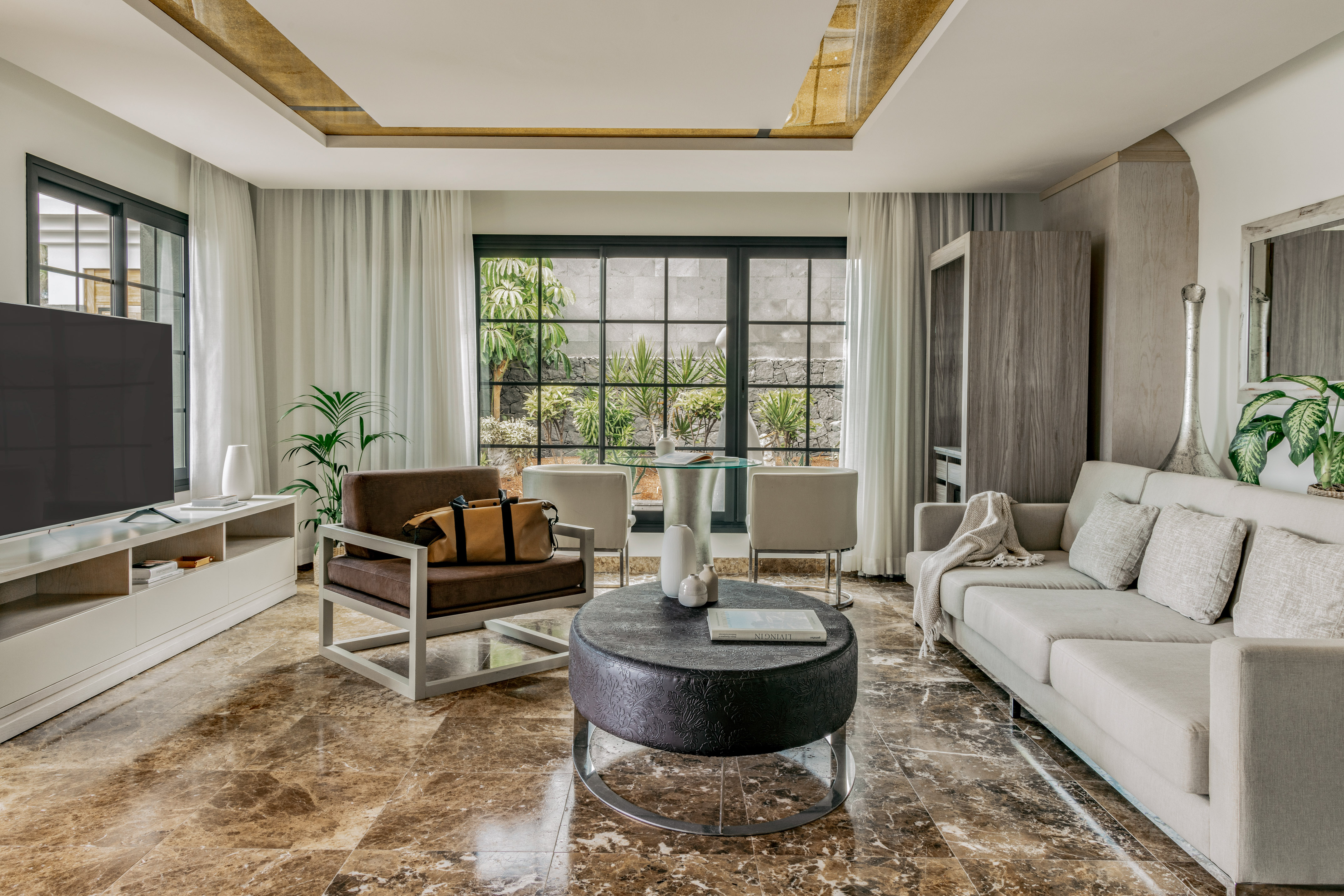 a living room with a couch and chairs