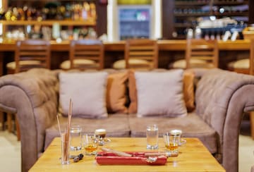 a table with glasses and a tray of liquid on it