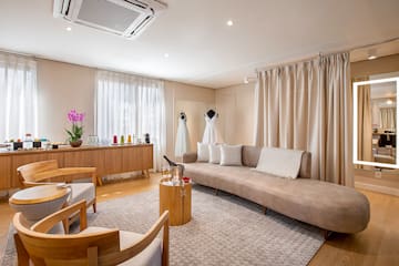 a room with a couch and a table and chairs