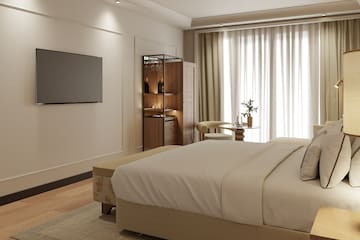 a bedroom with a tv and a bed