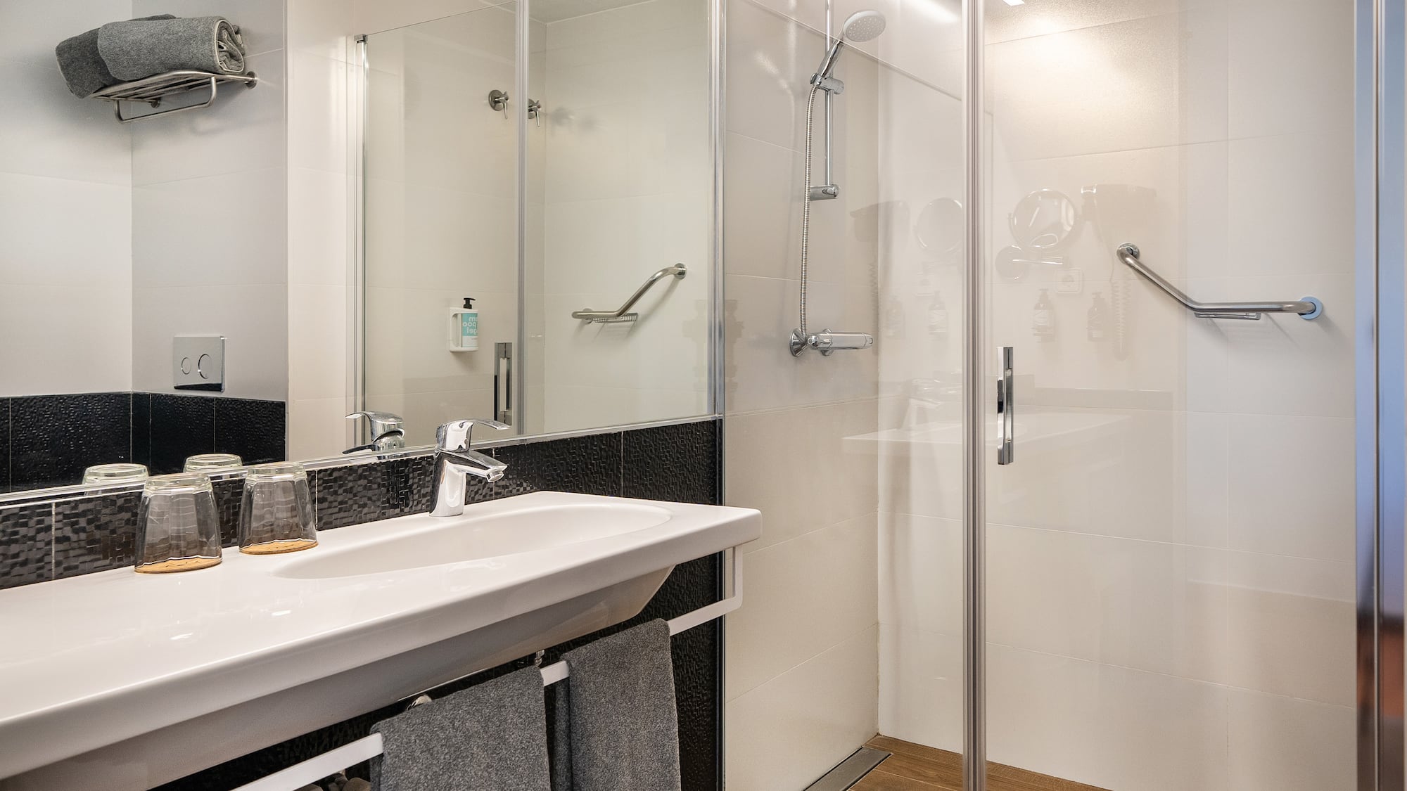 a bathroom with a shower and sink