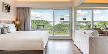 a room with a bed and couches