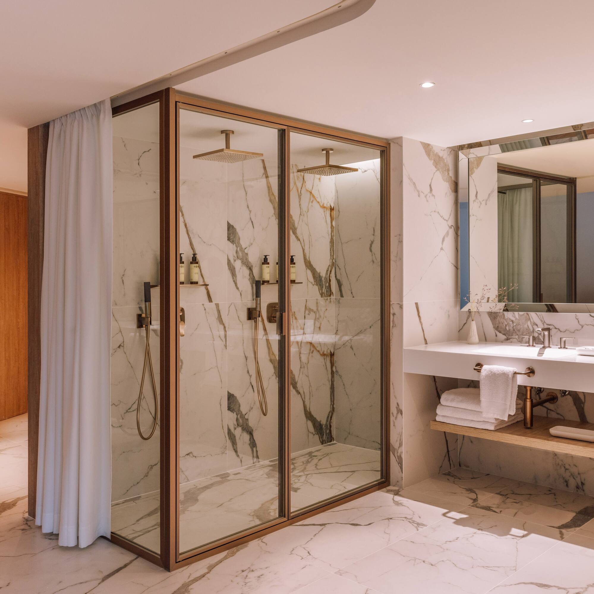 a bathroom with marble walls and shower