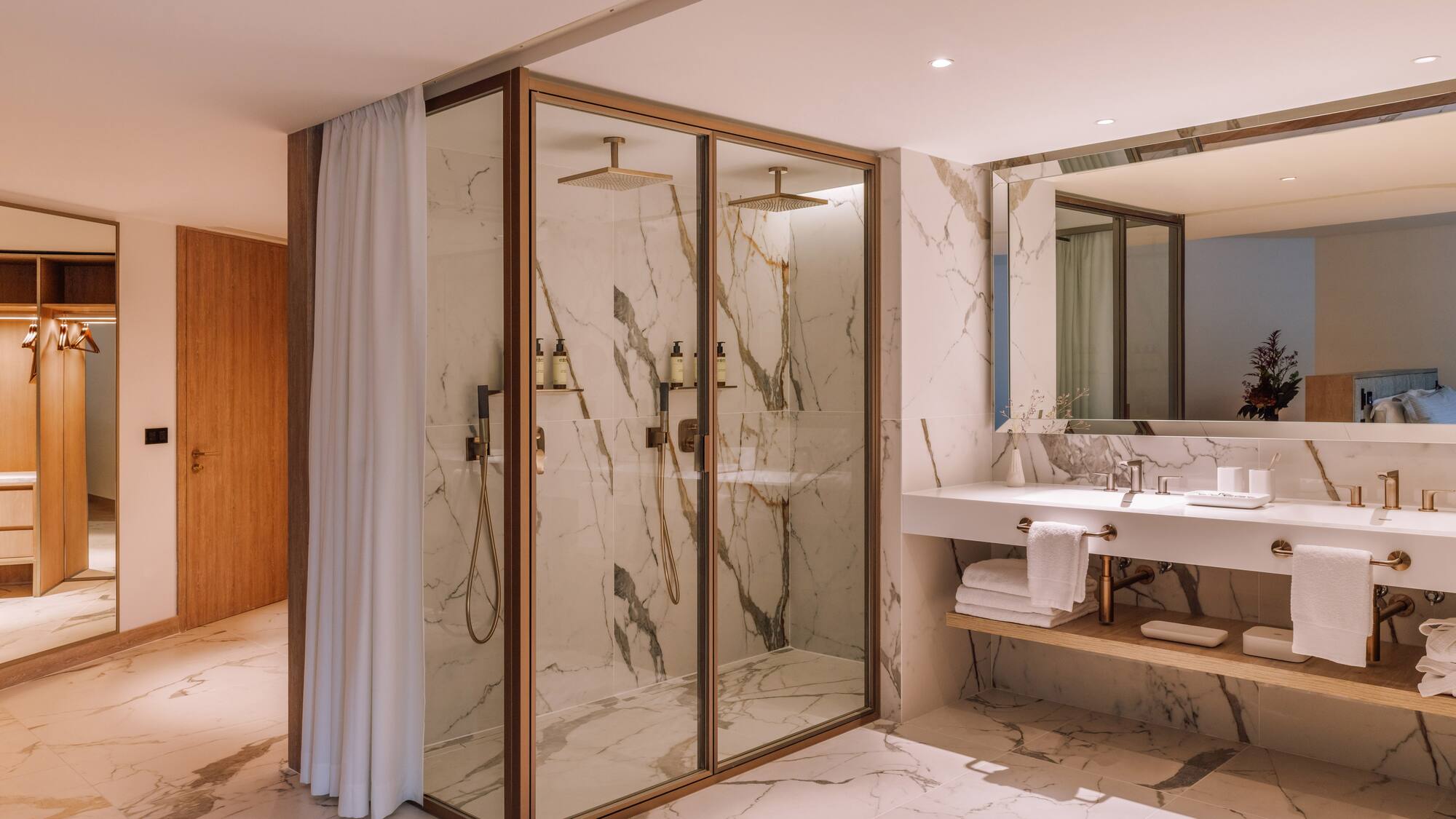 a bathroom with marble walls and shower