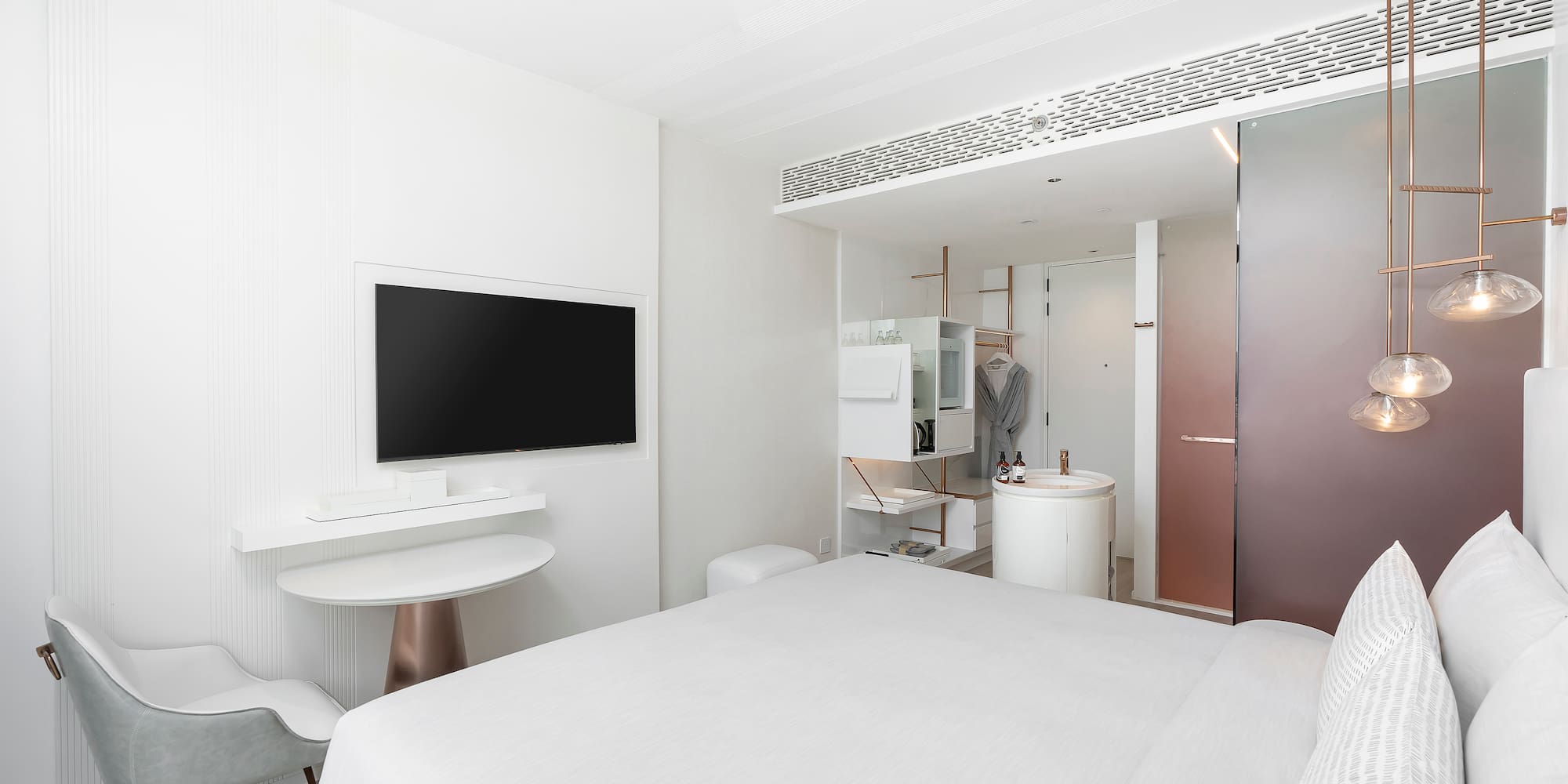 a room with a bed and a television