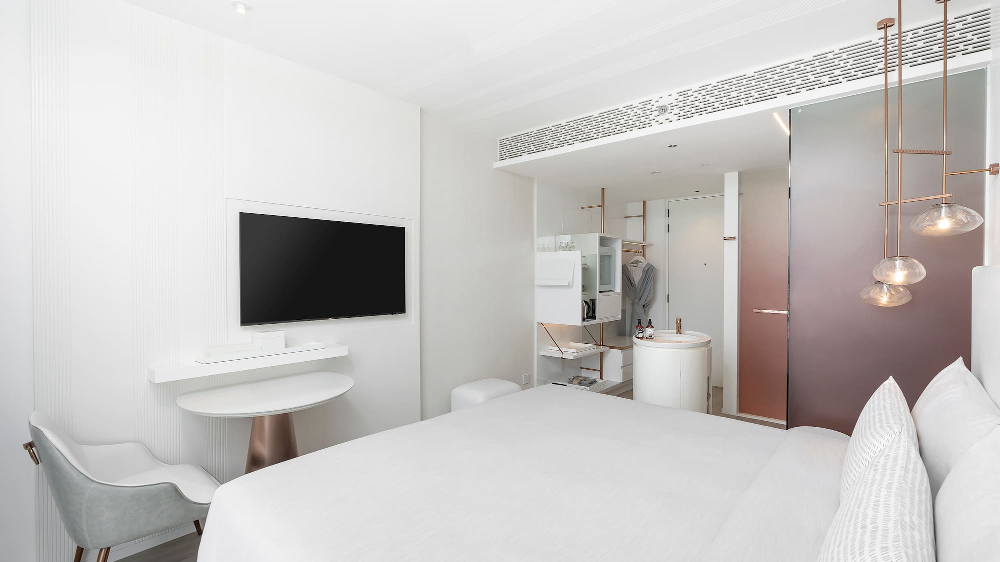 a room with a bed and a television