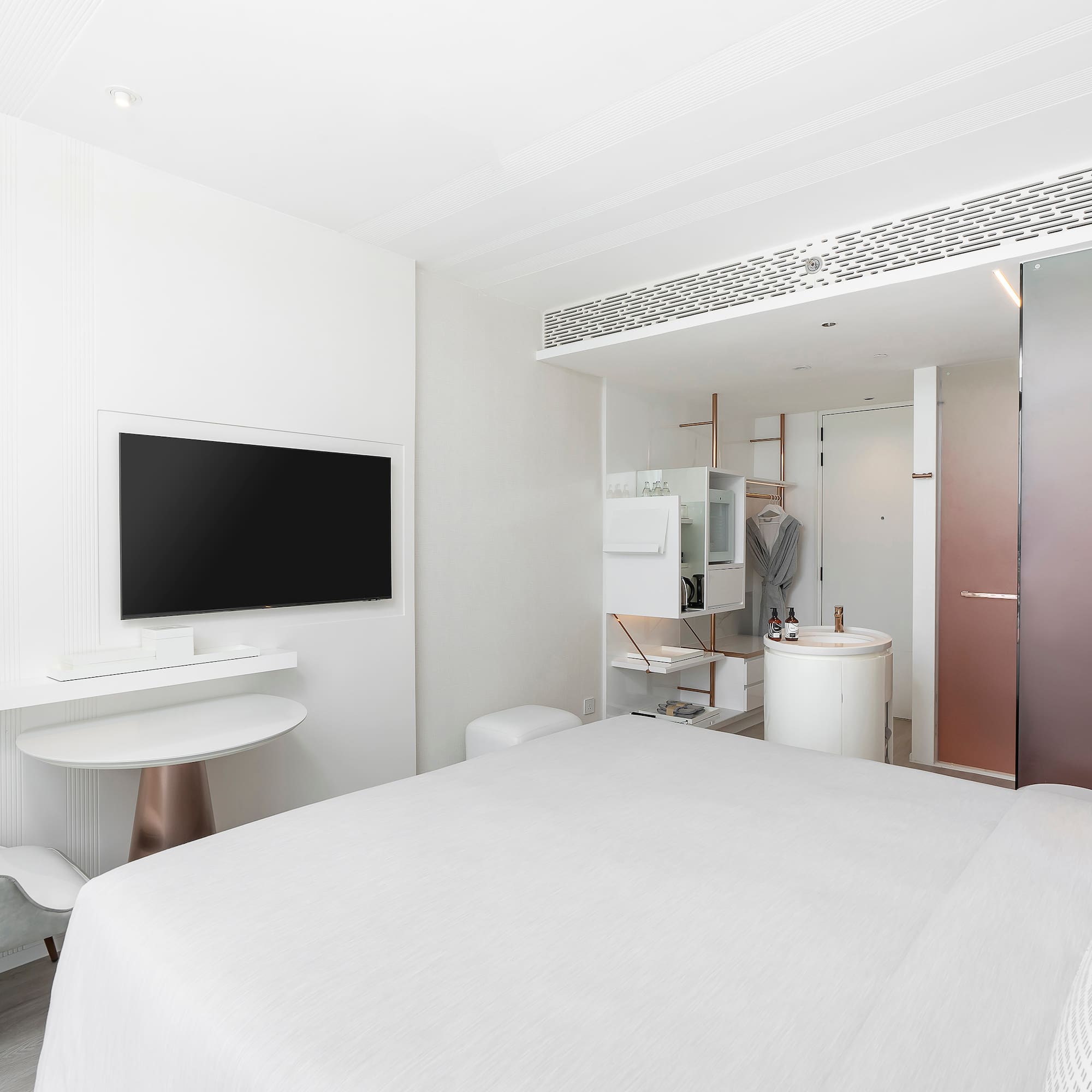 a room with a bed and a television