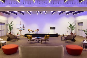 a room with a stage and chairs