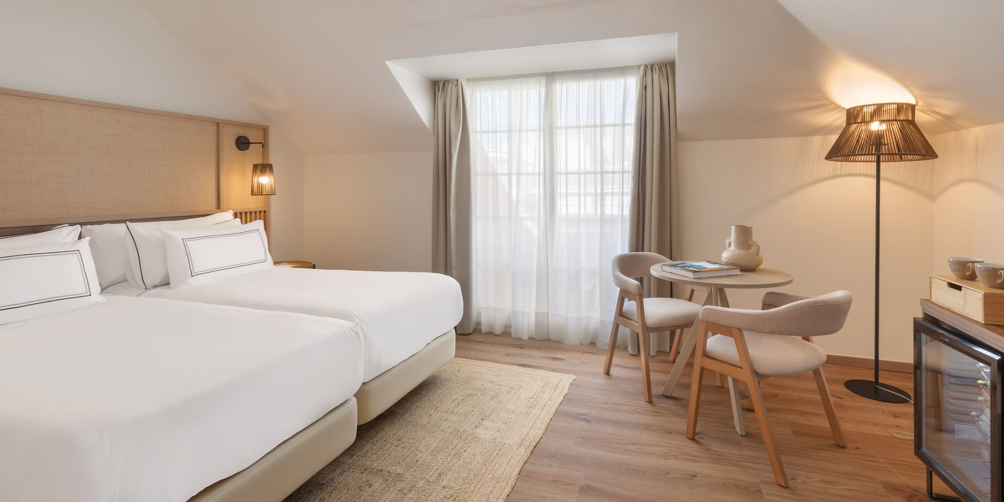 a room with two beds and a table