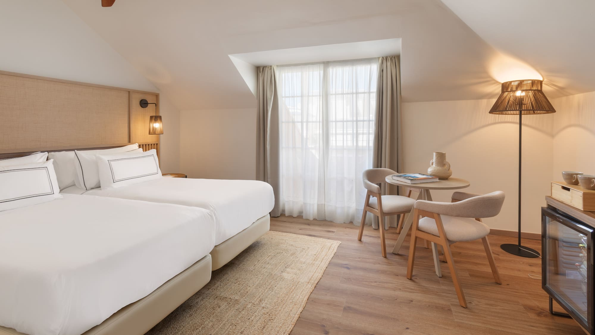 a room with two beds and a table