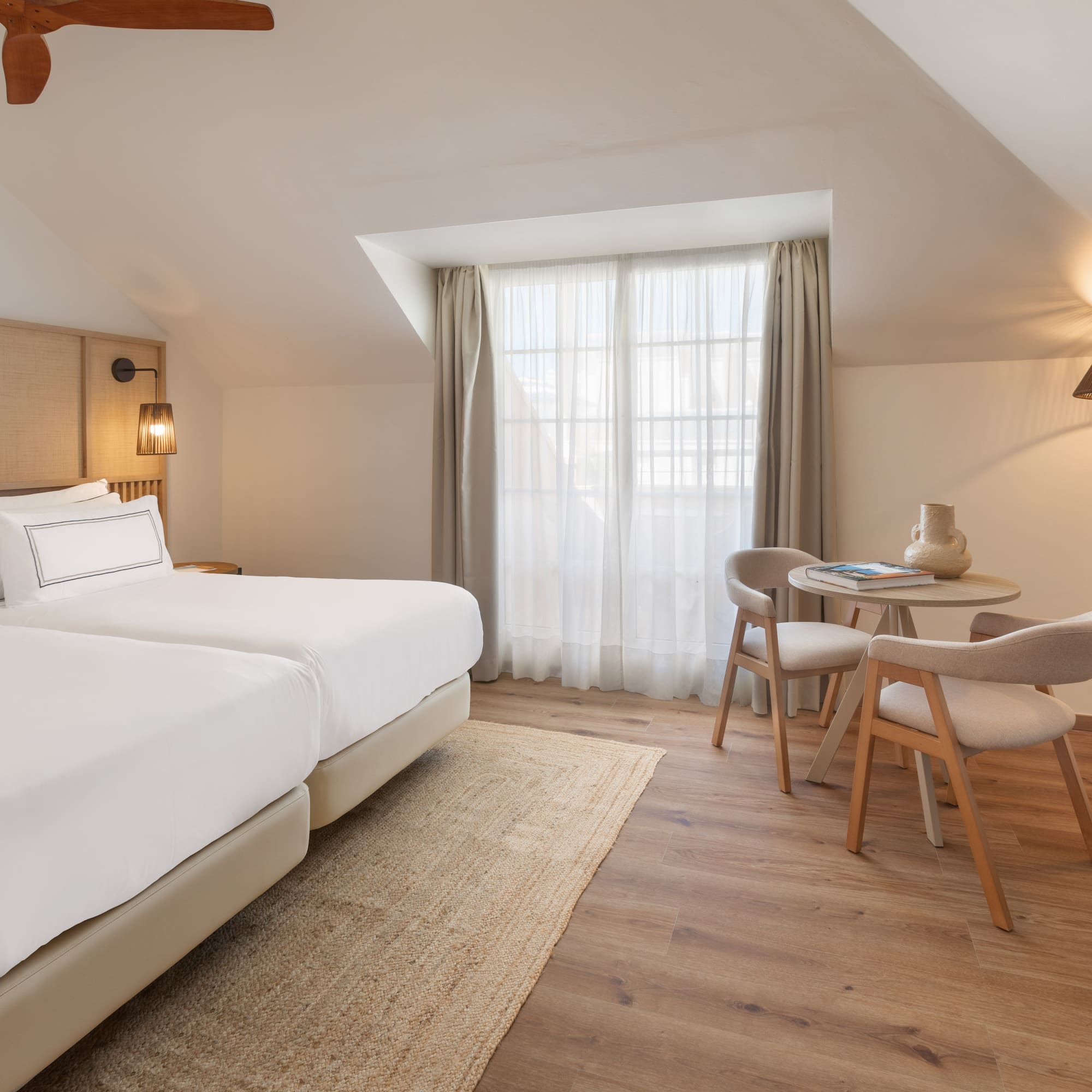 a room with two beds and a table