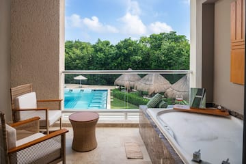 a tub and a pool outside of a room