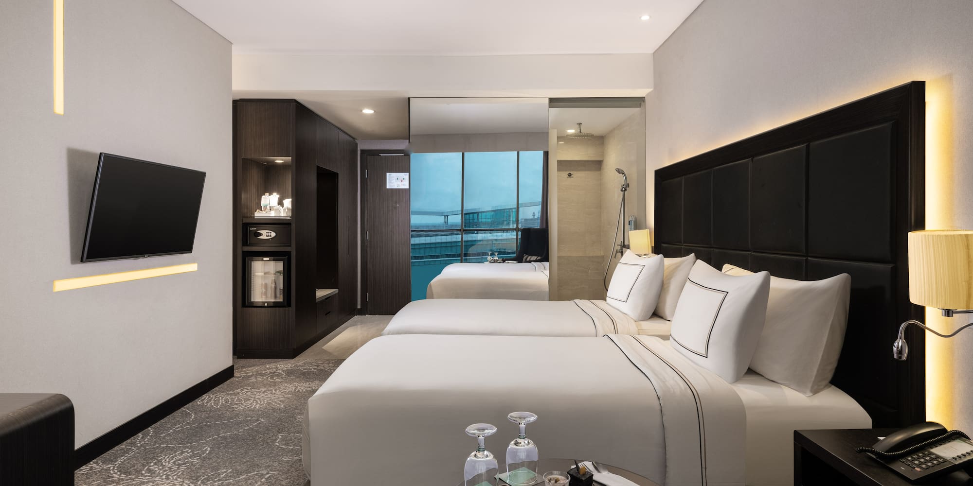 a room with two beds and a television