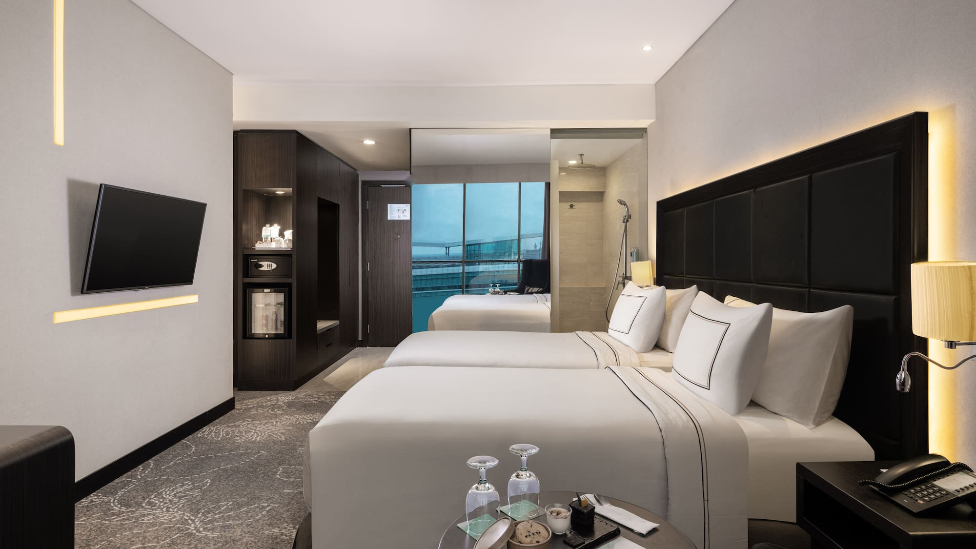 a room with two beds and a television