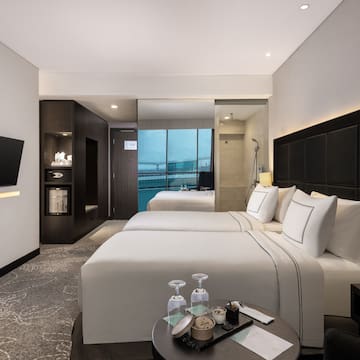 a room with two beds and a television