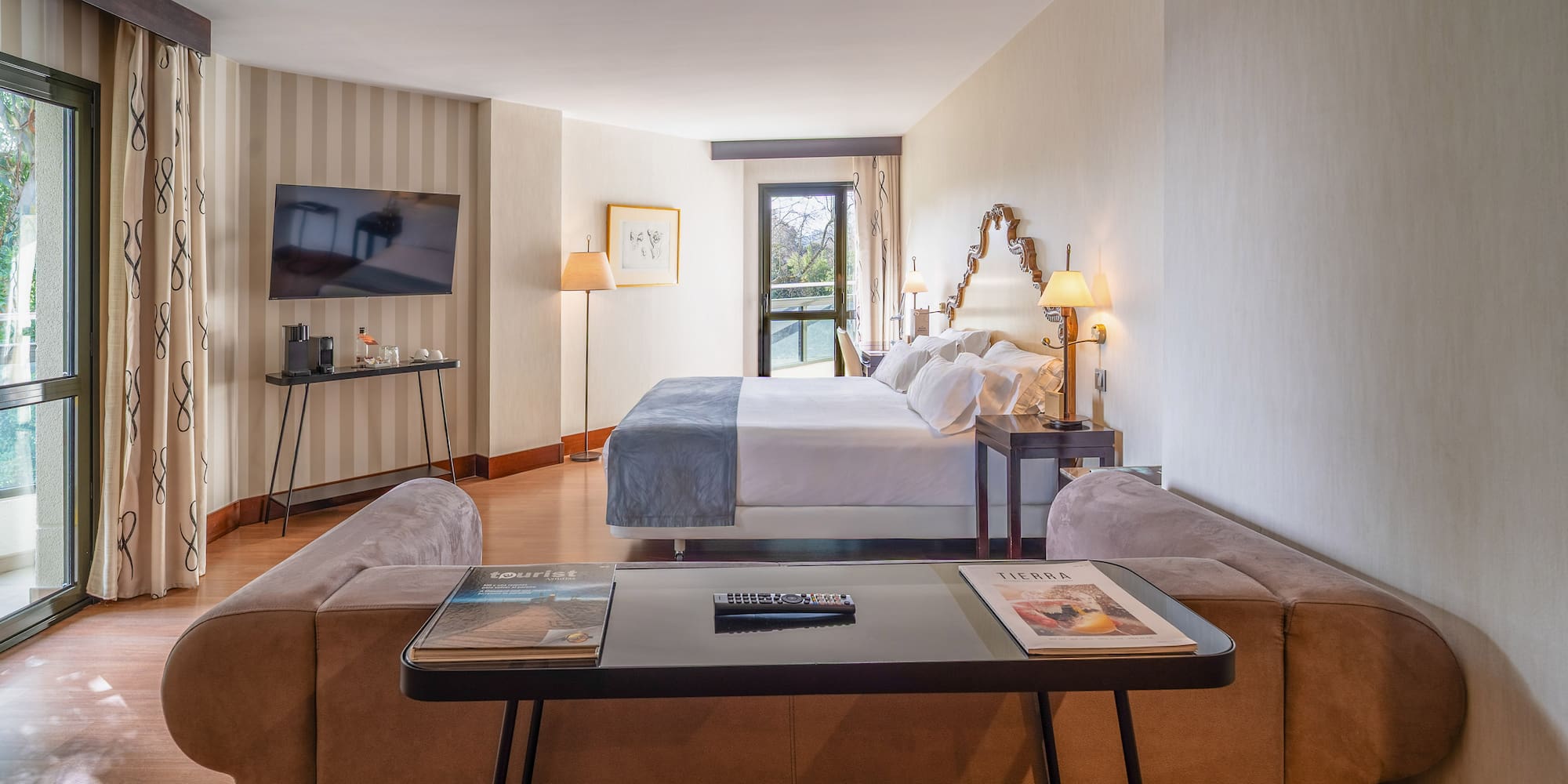 a room with a bed and a television