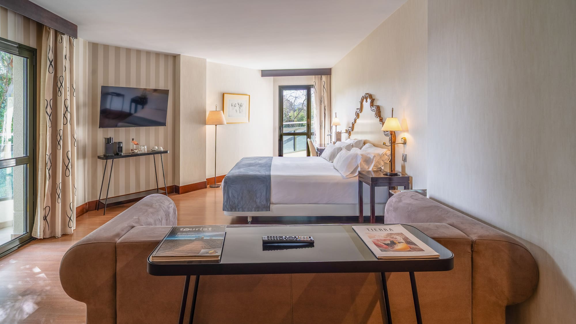 a room with a bed and a television