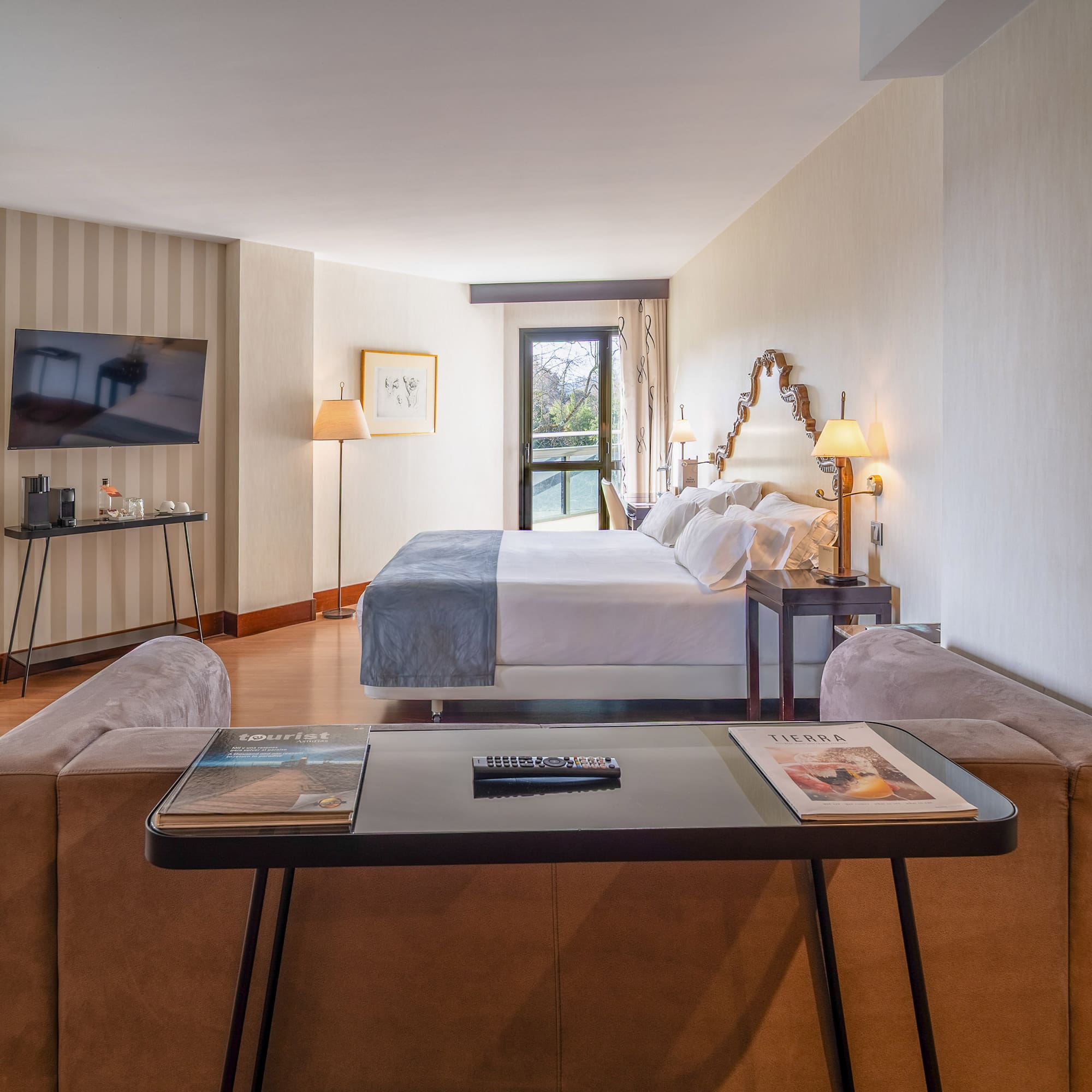 a room with a bed and a television