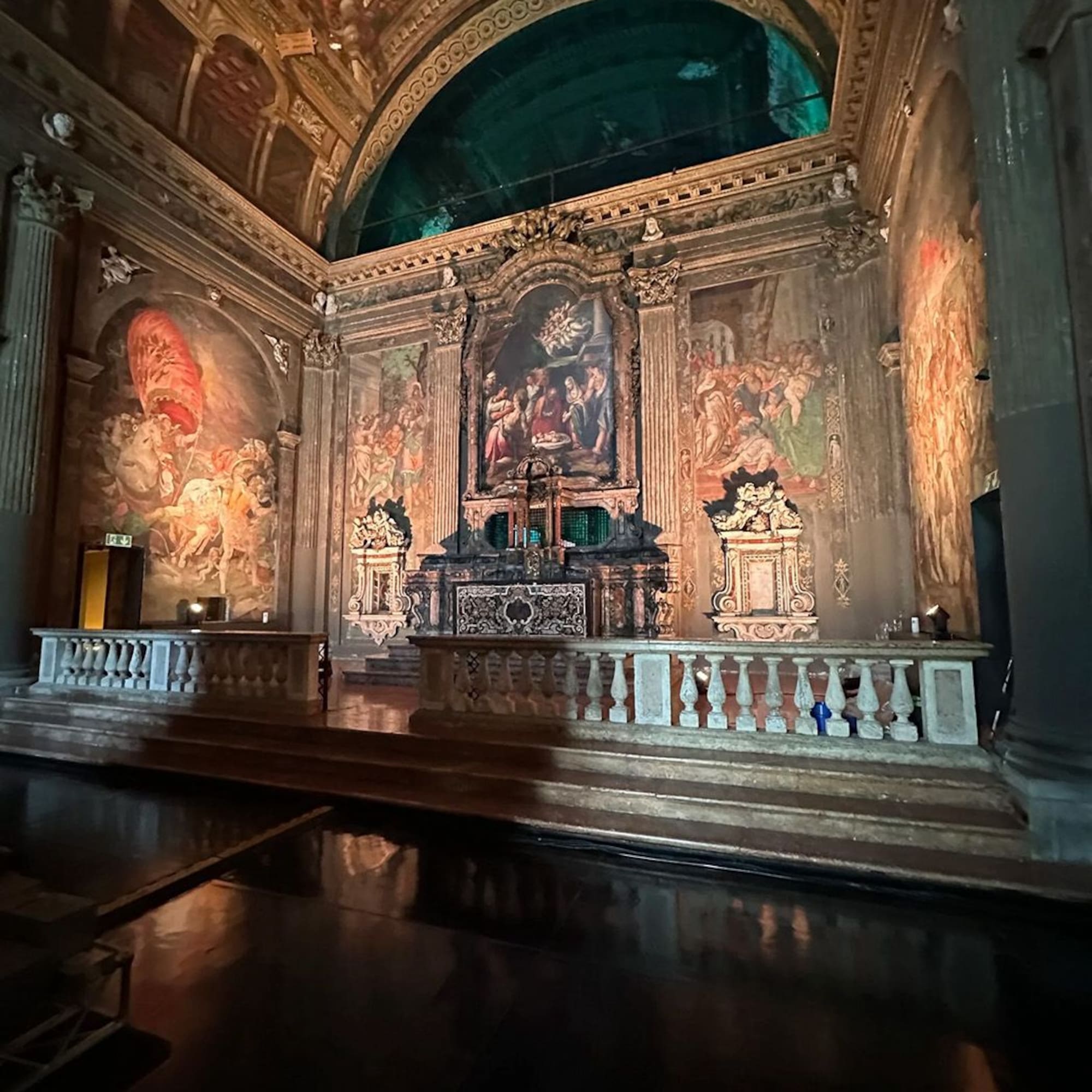 a large ornate room with a painting on the wall