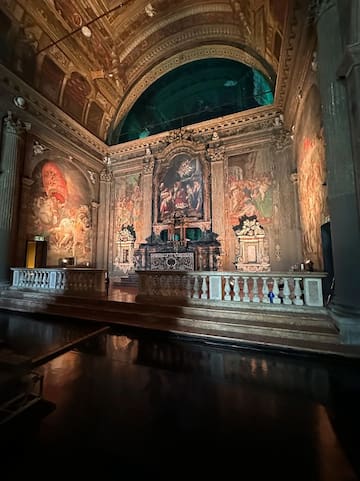 a large ornate room with a painting on the wall