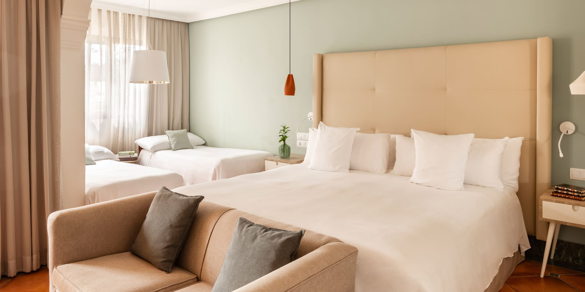 a room with two beds and a couch