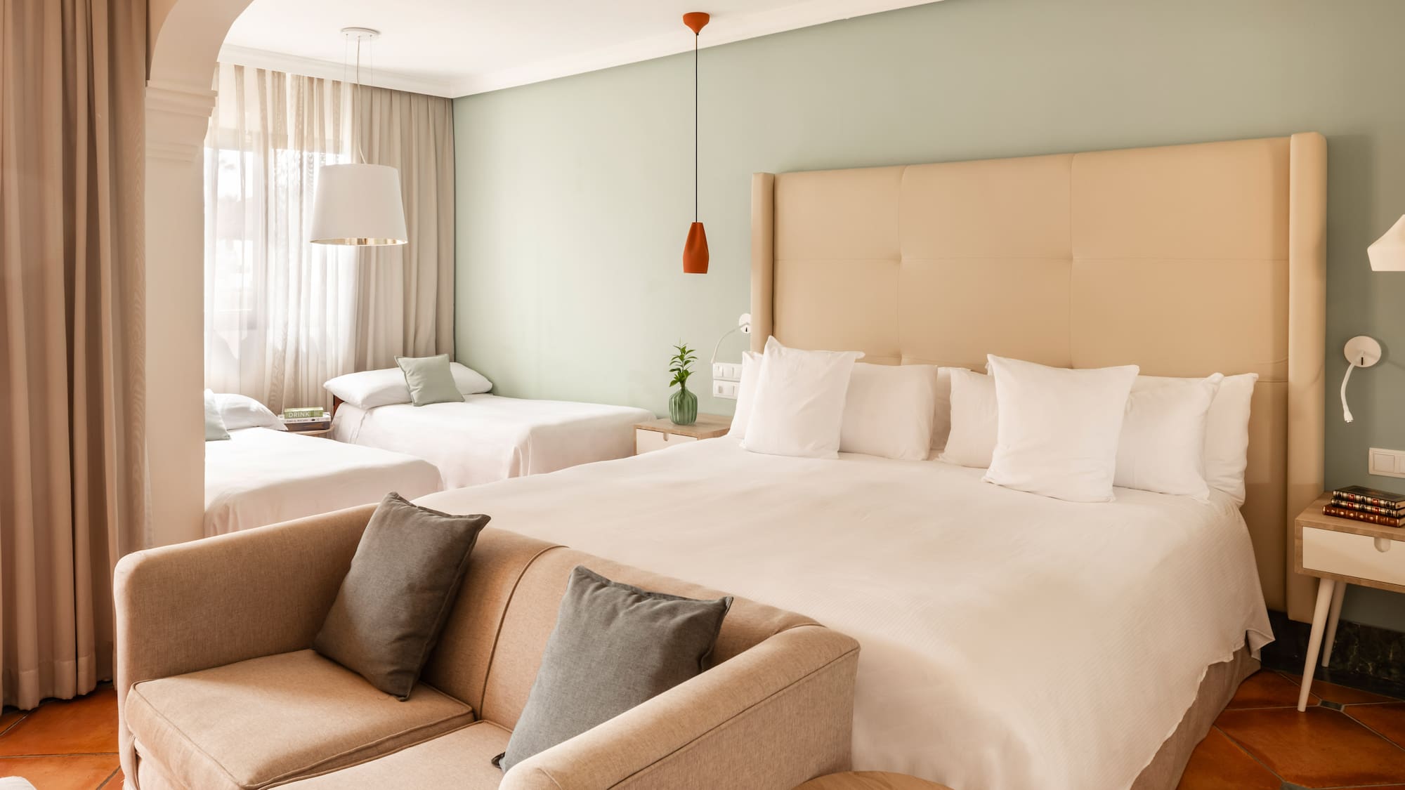 a room with two beds and a couch