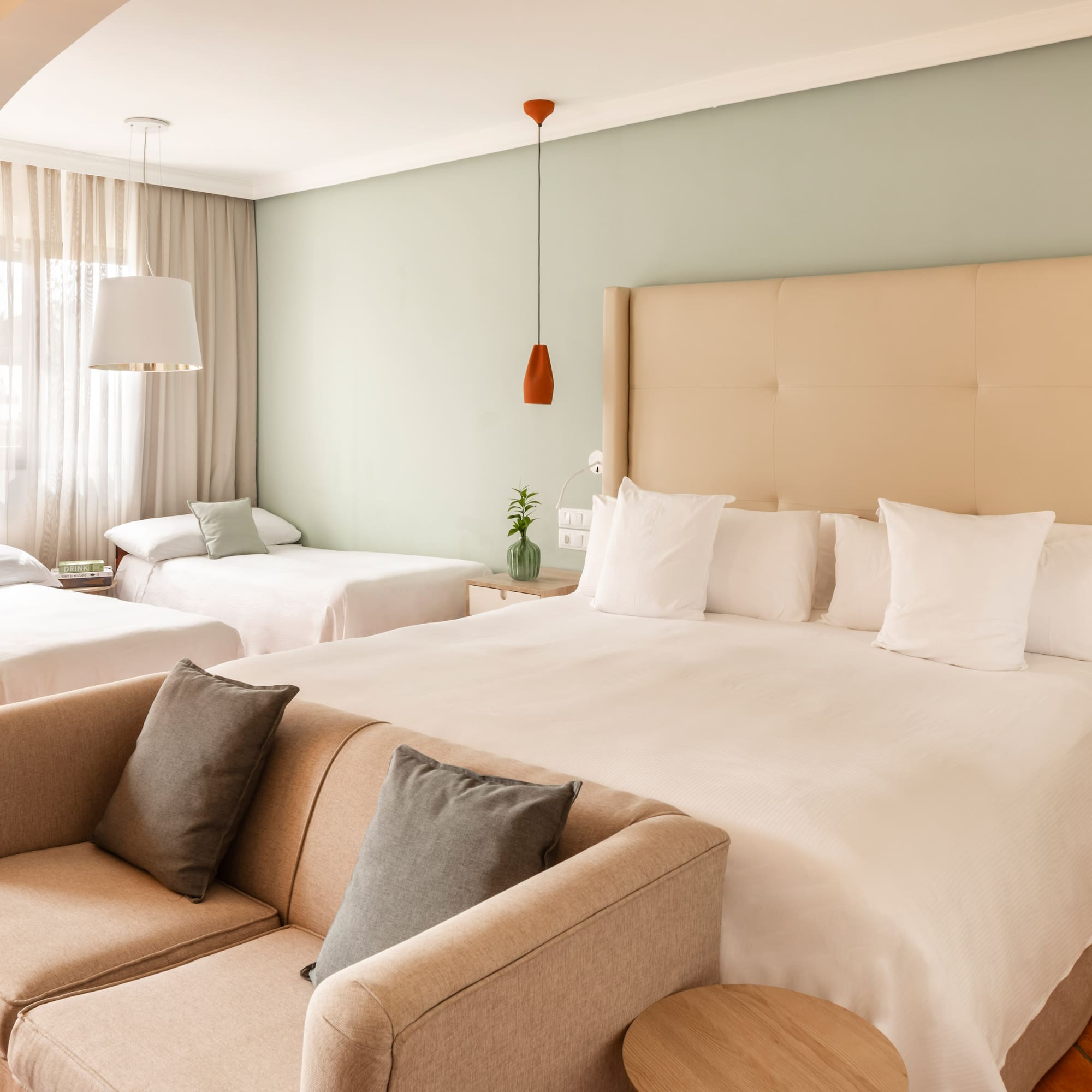 a room with two beds and a couch