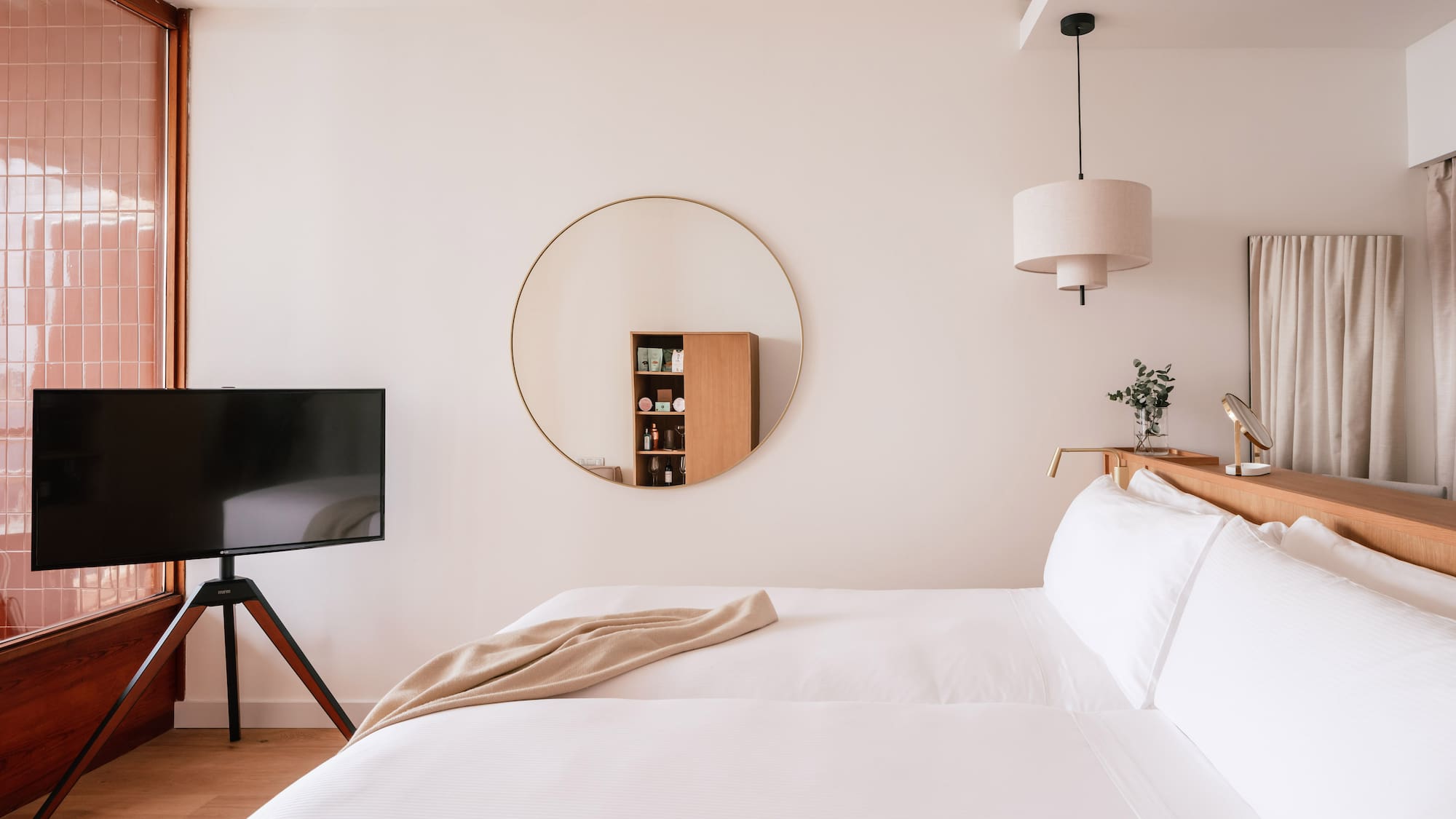 a room with a mirror and a bed