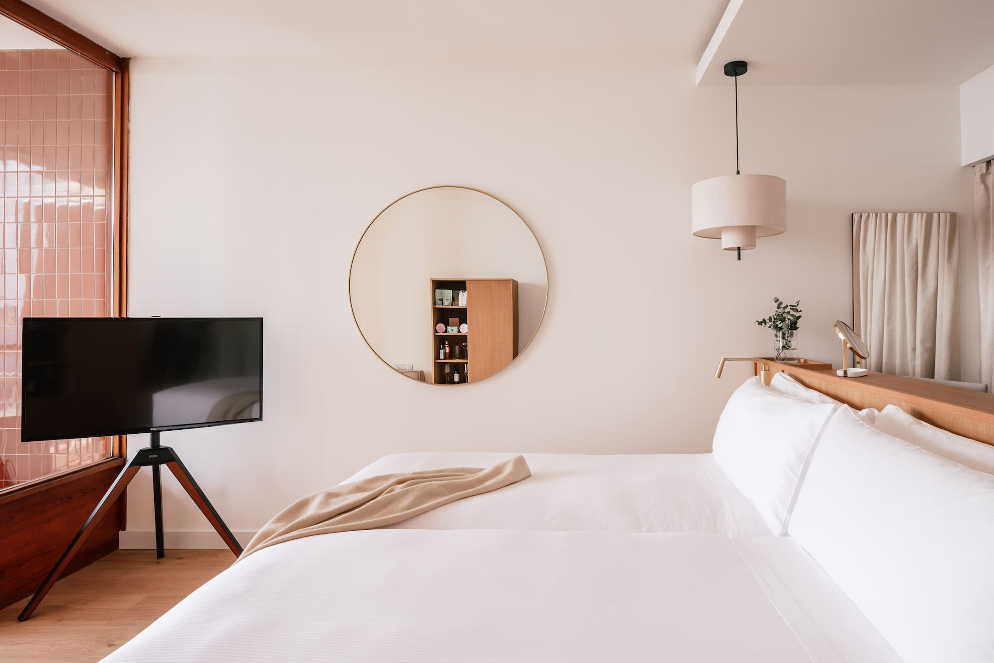 a room with a mirror and a bed