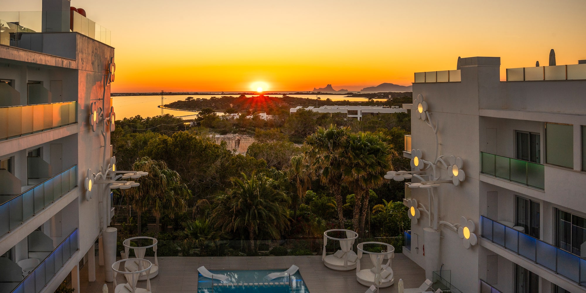 a pool with a deck and chairs in the foreground