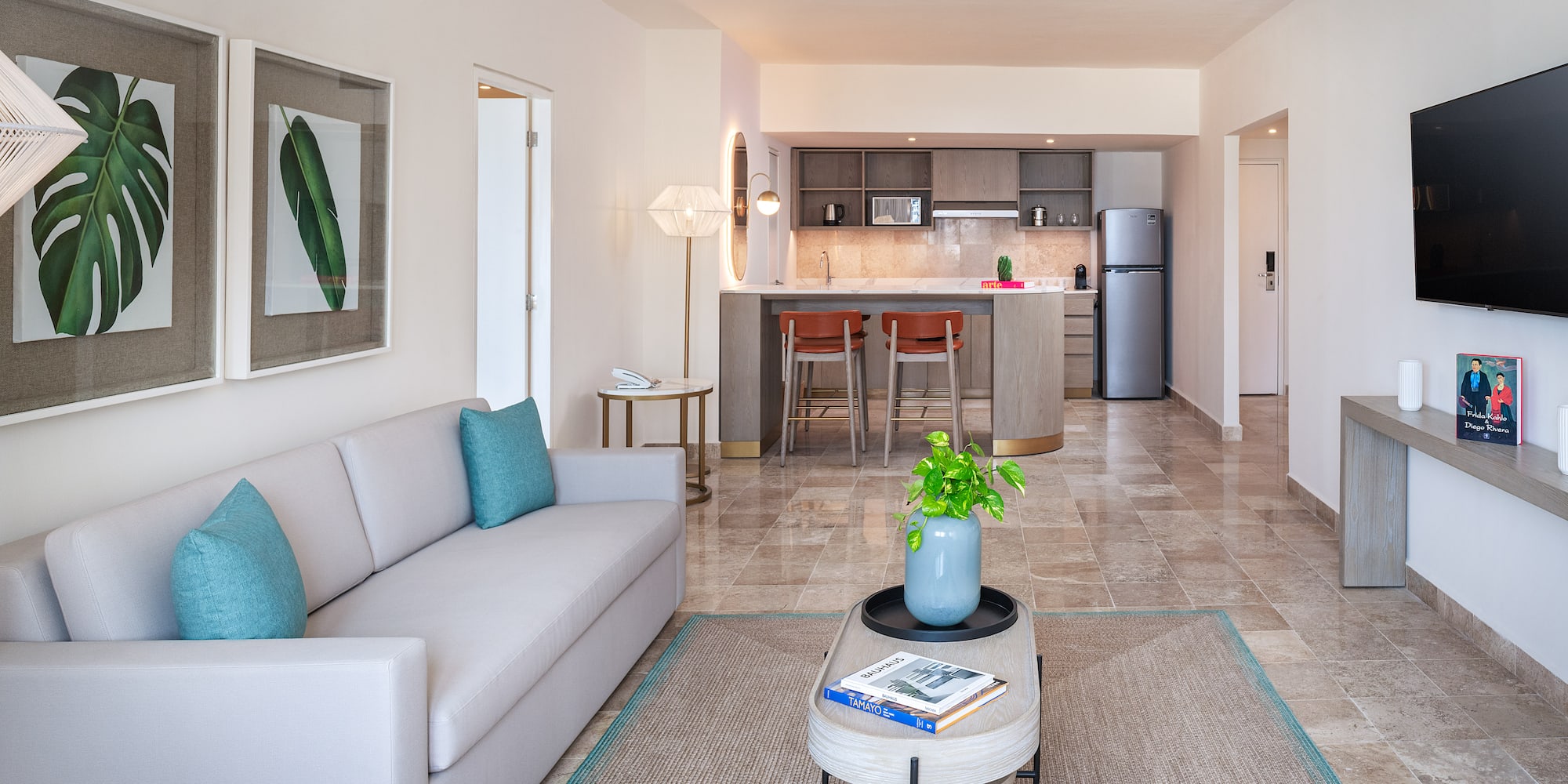 a living room with a couch and a kitchen