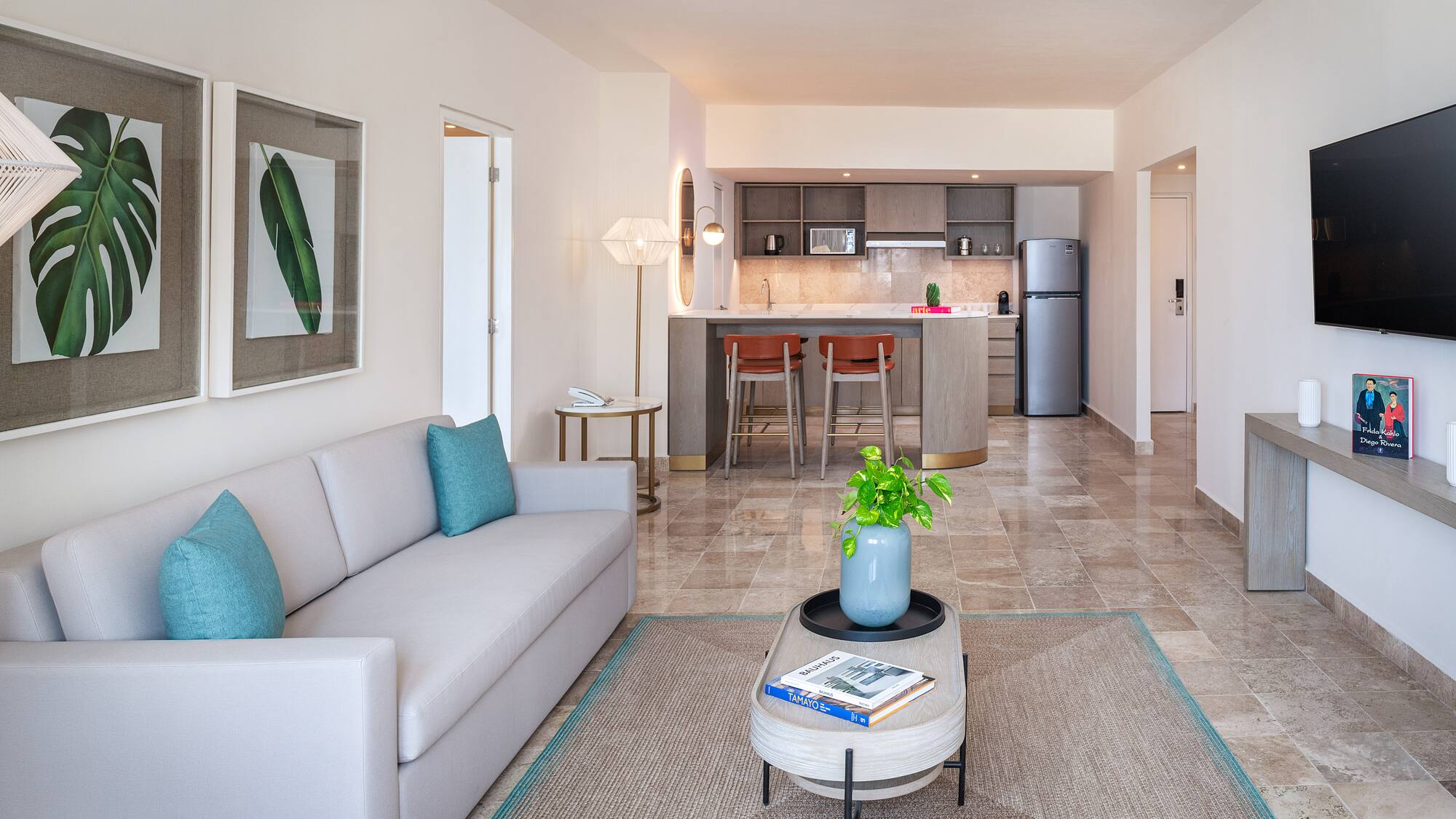 a living room with a couch and a kitchen