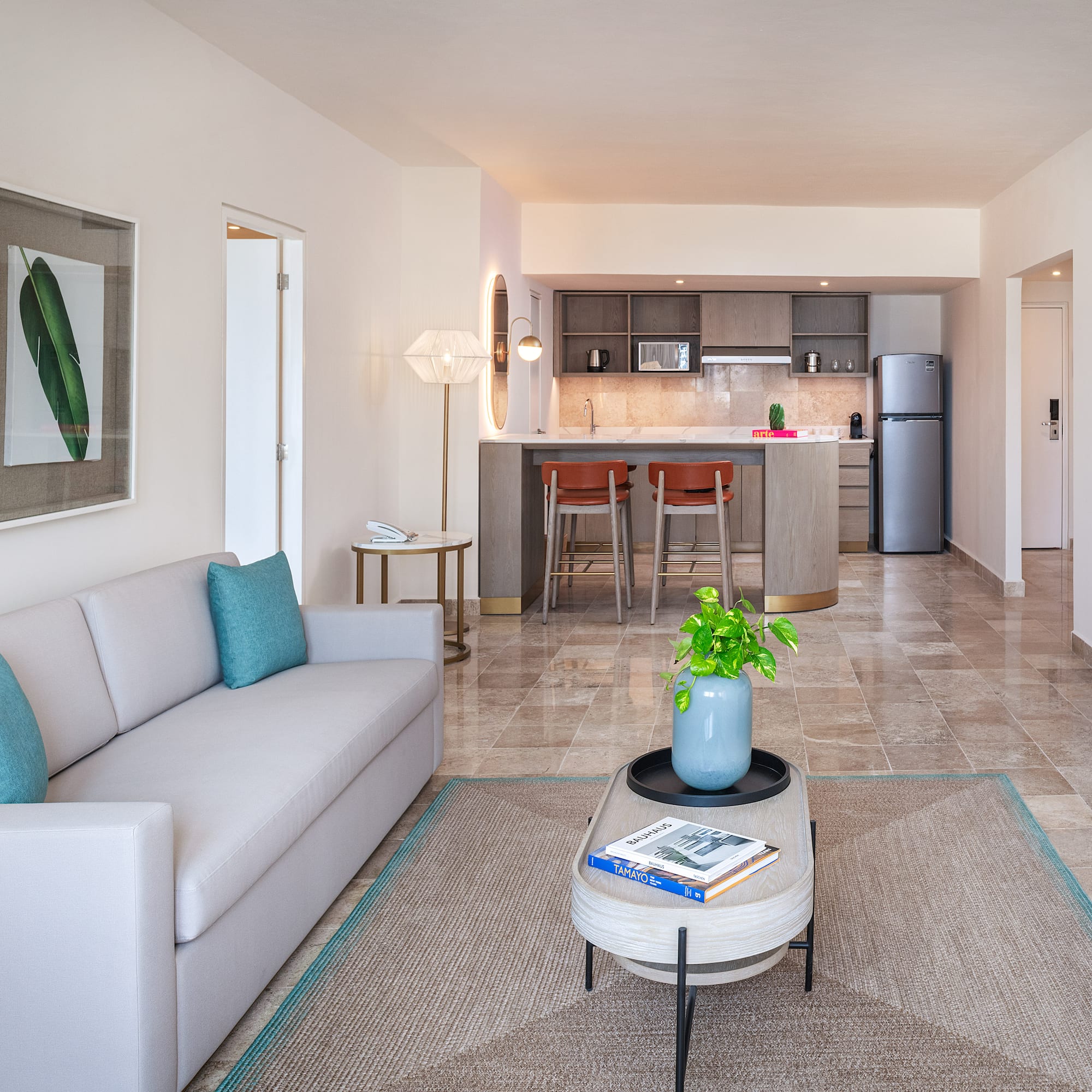 a living room with a couch and a kitchen