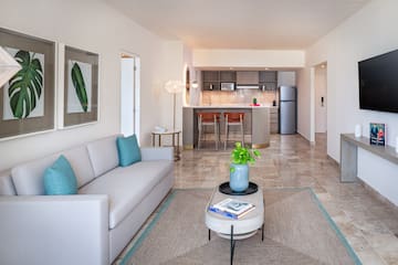 a living room with a couch and a kitchen