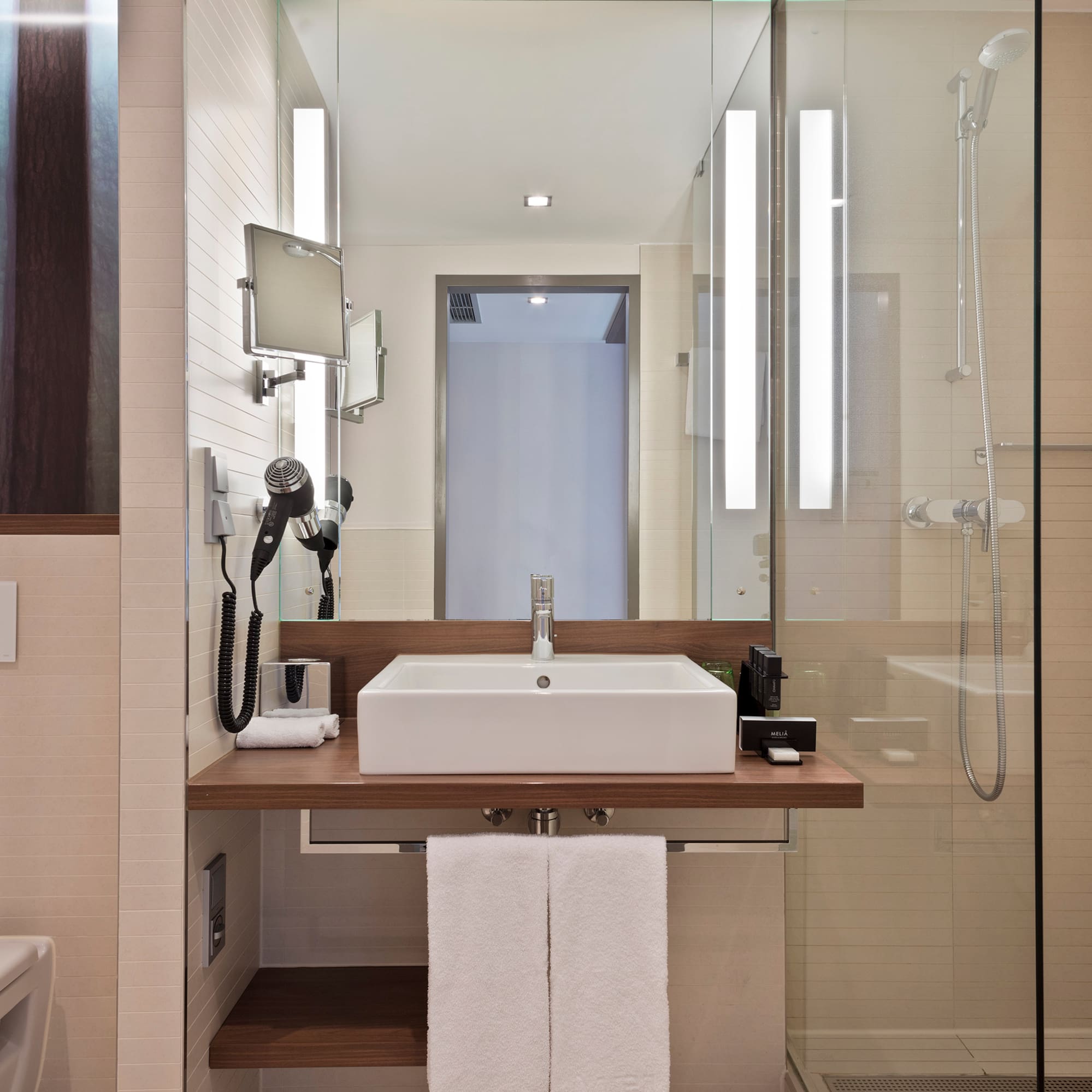 a bathroom with a glass shower and sink