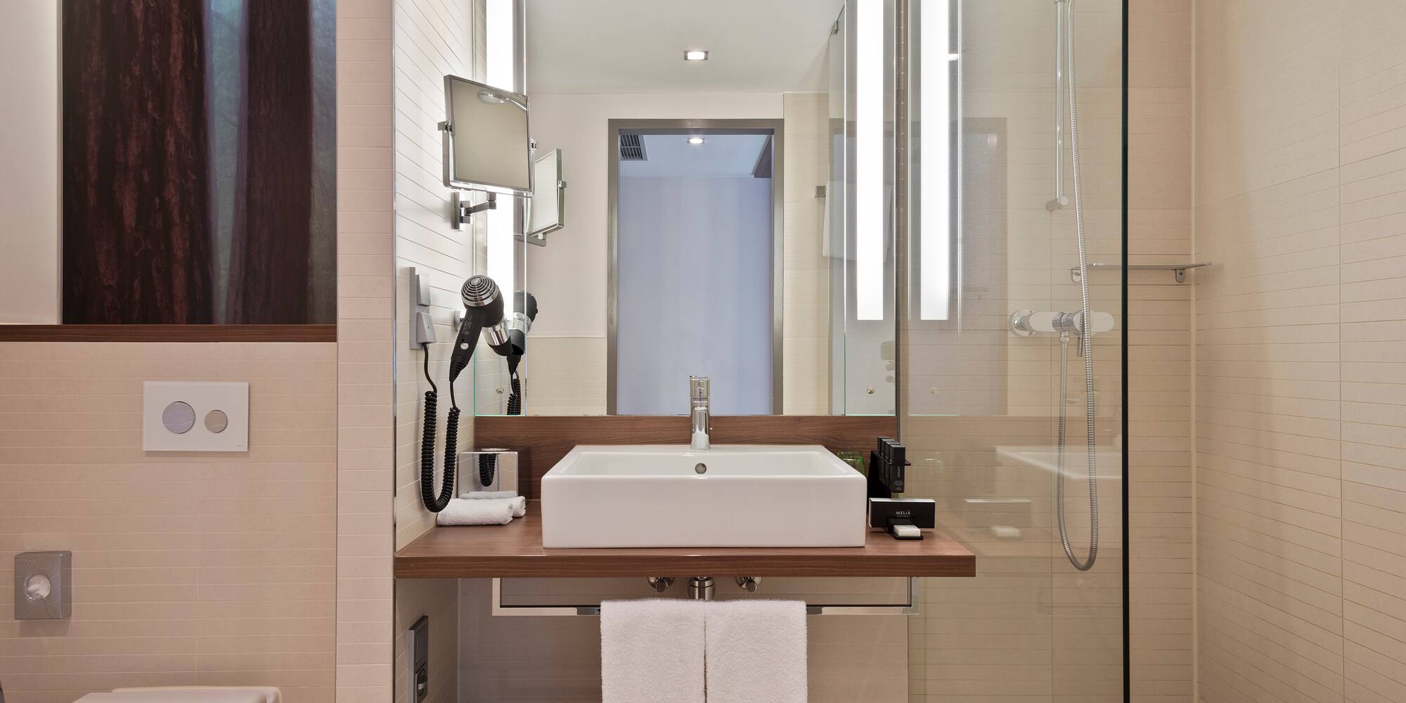 a bathroom with a glass shower and sink