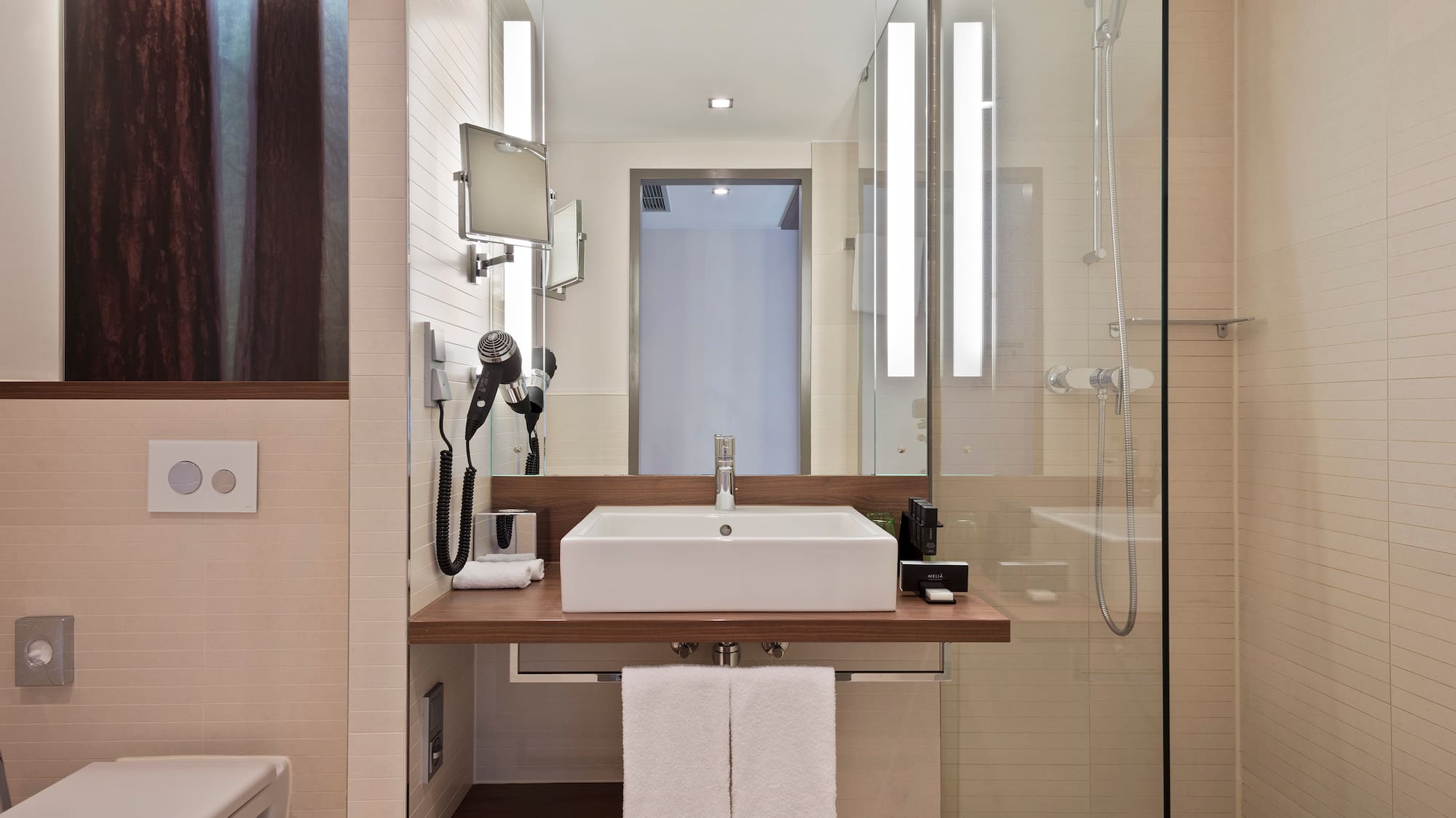 a bathroom with a glass shower and sink