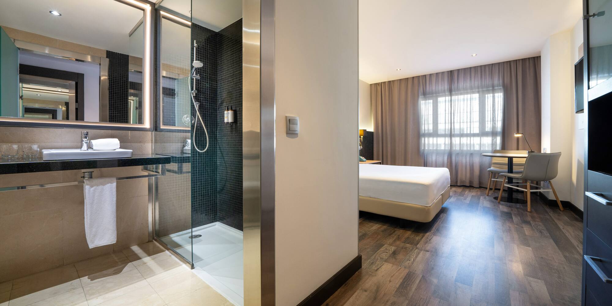a bathroom with a shower and a bed