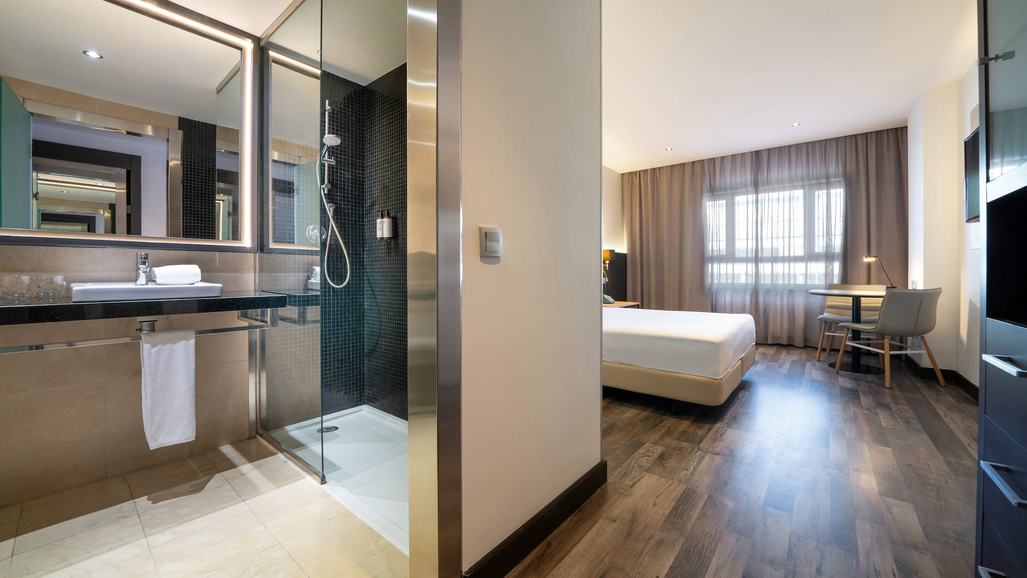 a bathroom with a shower and a bed