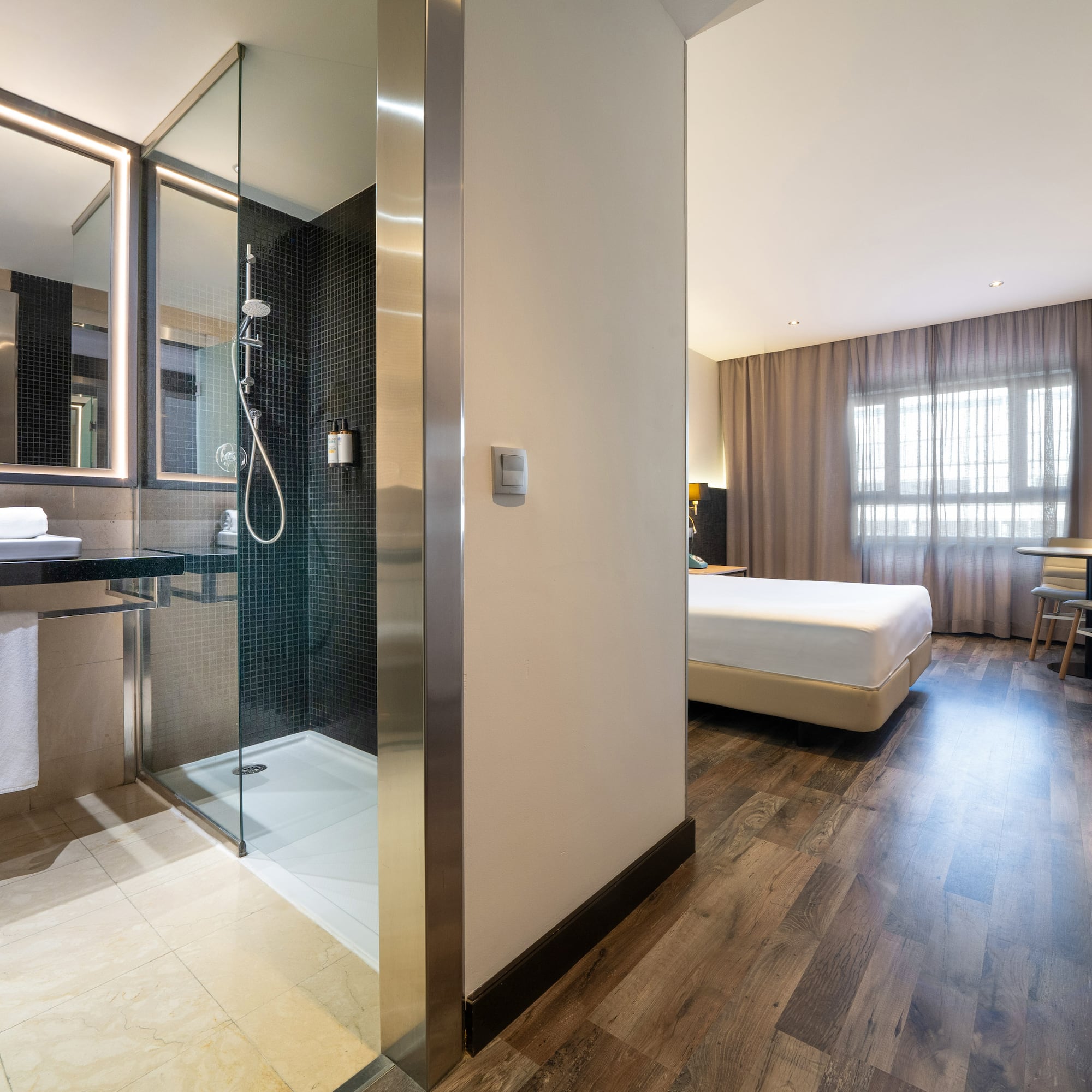 a bathroom with a shower and a bed